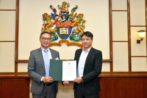 Mr. Roger Lee (right) receiving a Certificate of Appreciation from Ir. Ricky Lau, JP (left)